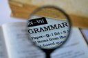 Magnifying glass showing the word 'grammar'